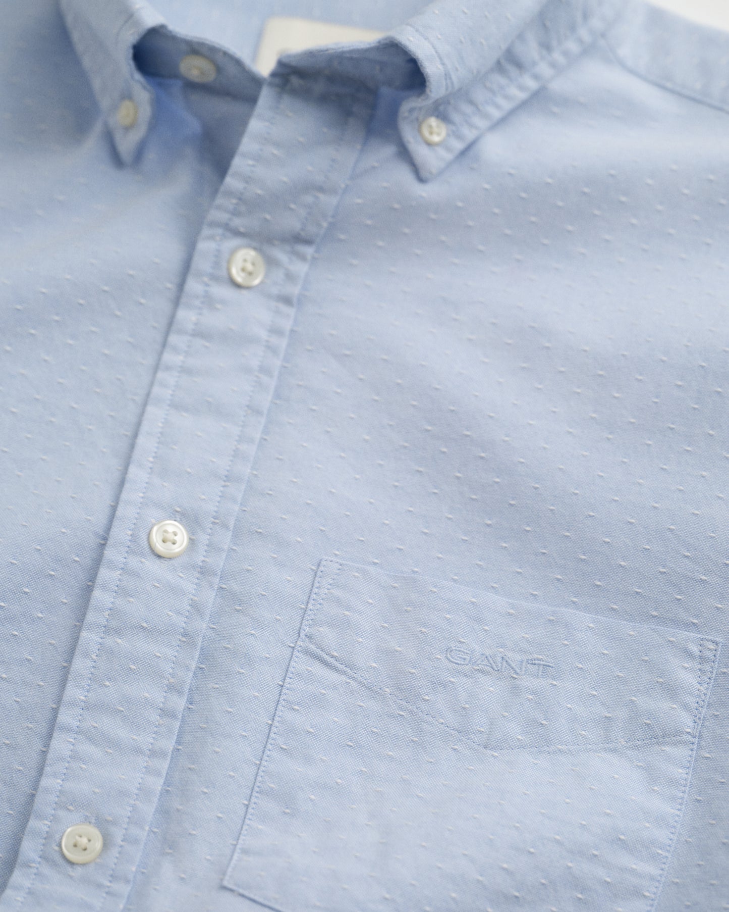 LIGHT BLUE, REG OXFORD DOBBY DOT SHIRT, FLAT-LAY BY GANT AU.