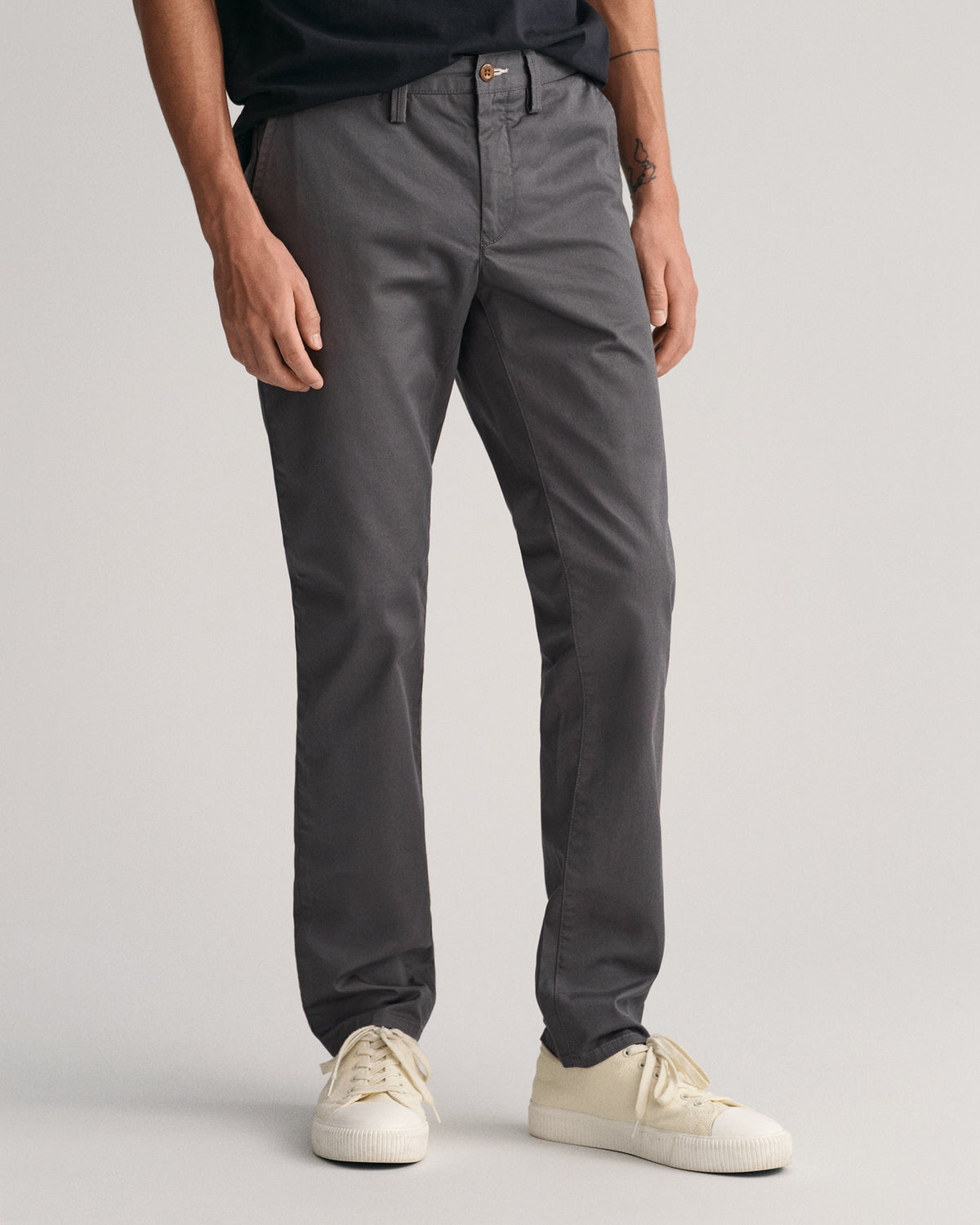 MODEL WEARING SLIM TWILL CHINOS