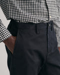 MODEL WEARING REGULAR TWILL CHINOS