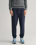 MODEL WEARING REG SHIELD SWEATPANTS