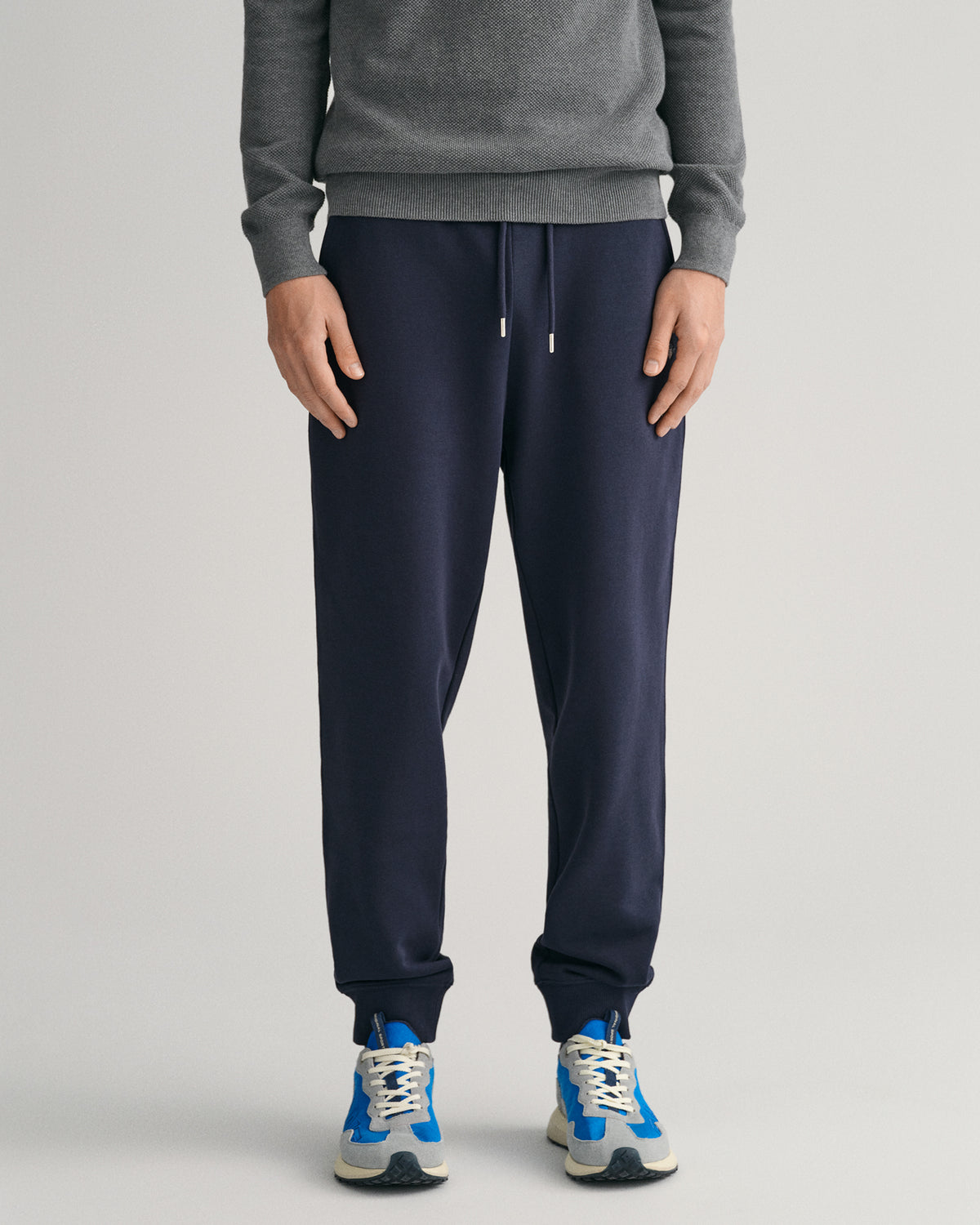 MODEL WEARING REG SHIELD SWEATPANTS