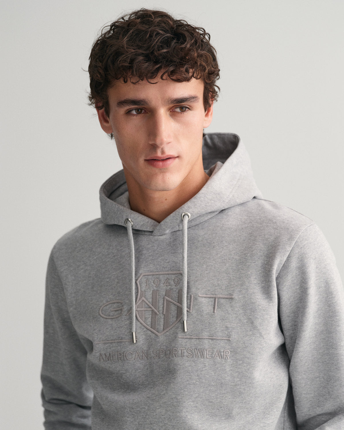 MODEL WEARING REG TONAL SHIELD HOODIE