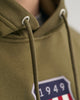 JUNIPER GREEN, REG ARCHIVE SHIELD HOODIE, CLOSE-UP BY GANT AU.