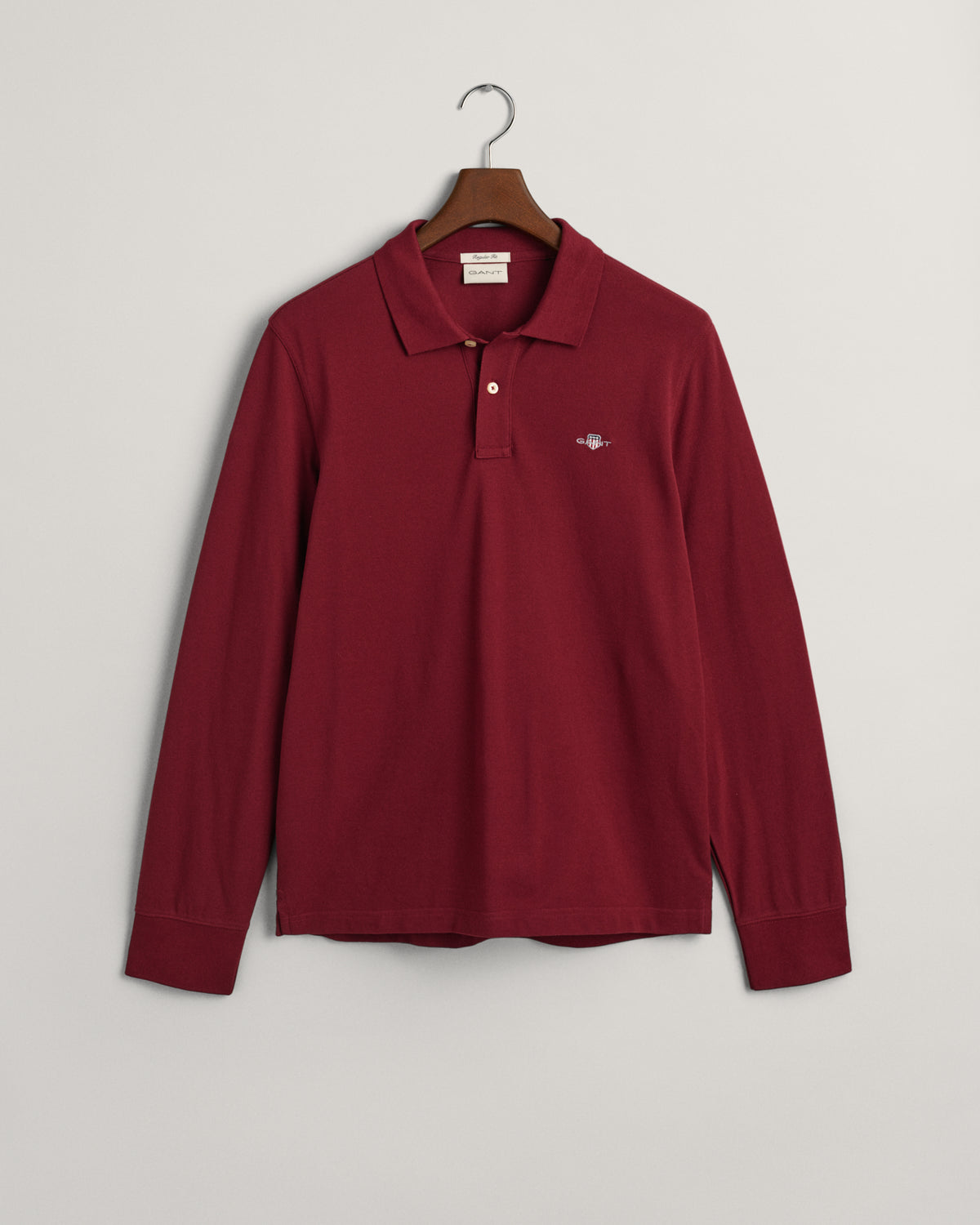 PLUMPED RED, REG SHIELD LS PIQUE POLO, FLAT-LAY BY GANT AU.