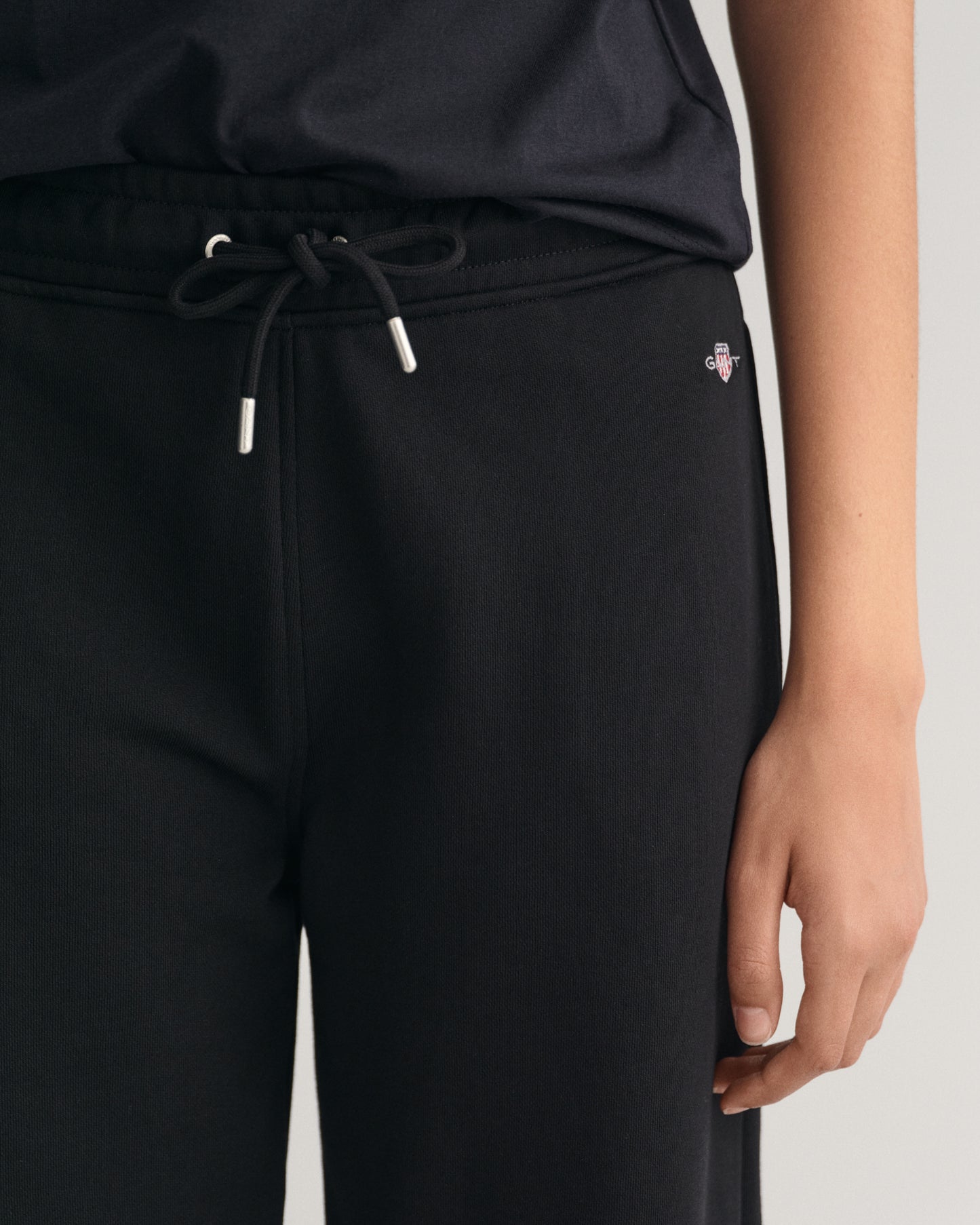 MODEL WEARING SHIELD SWEATPANTS
