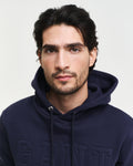 MODEL WEARING EMBOSSED SWEAT HOODIE