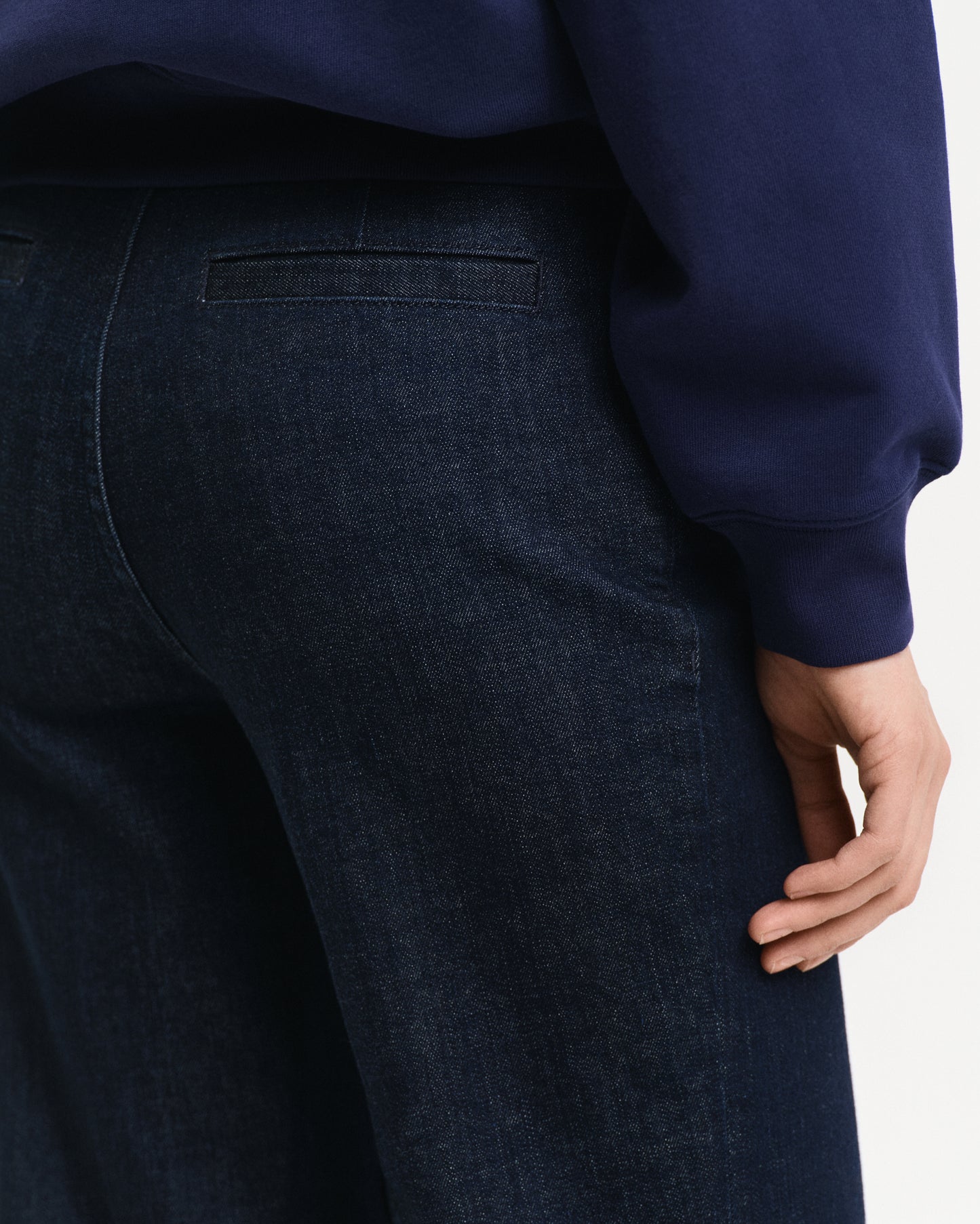 MODEL WEARING CROPPED CREASED DENIM