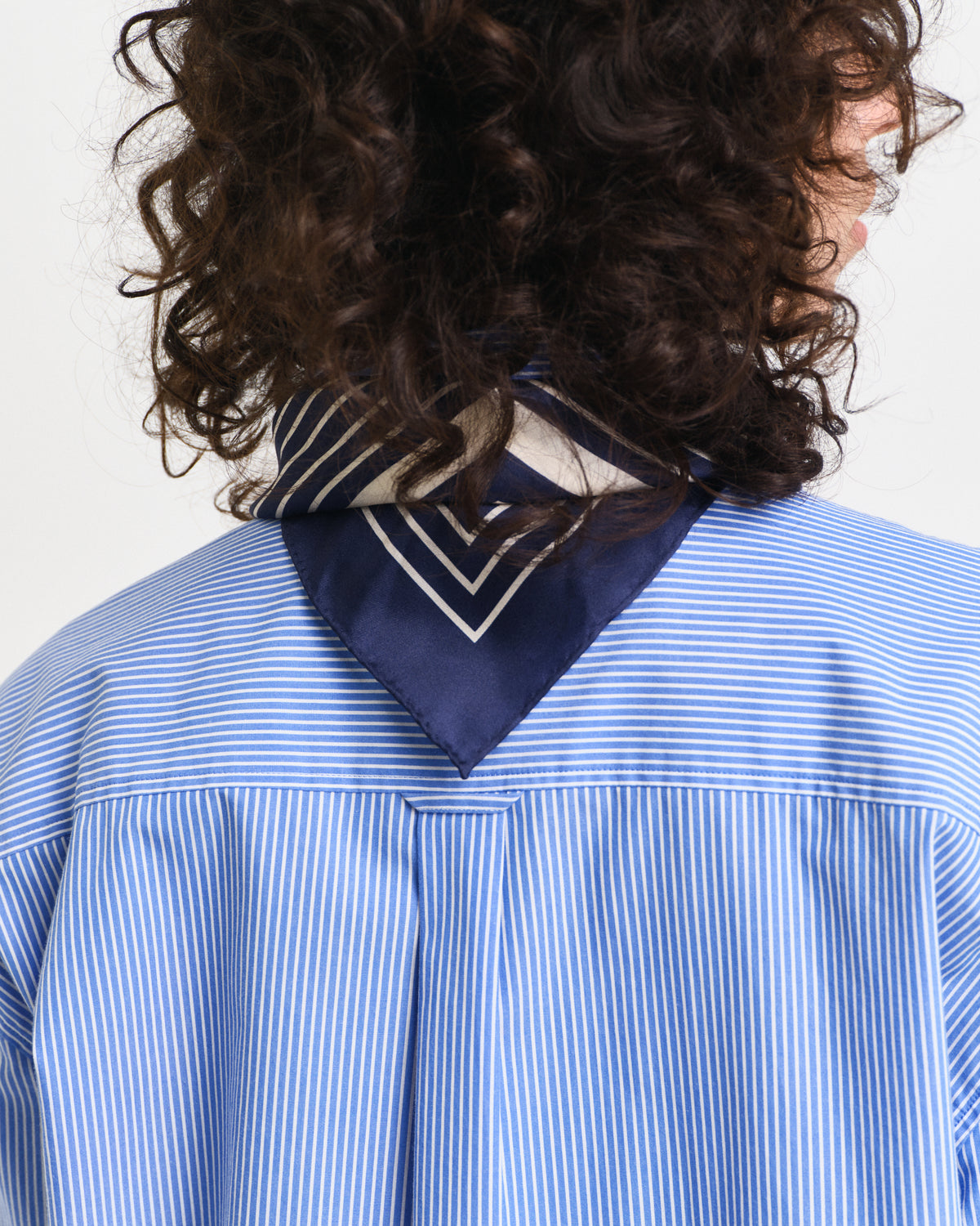 MODEL WEARING REL CLASSIC POPLIN STRIPED SHIRT