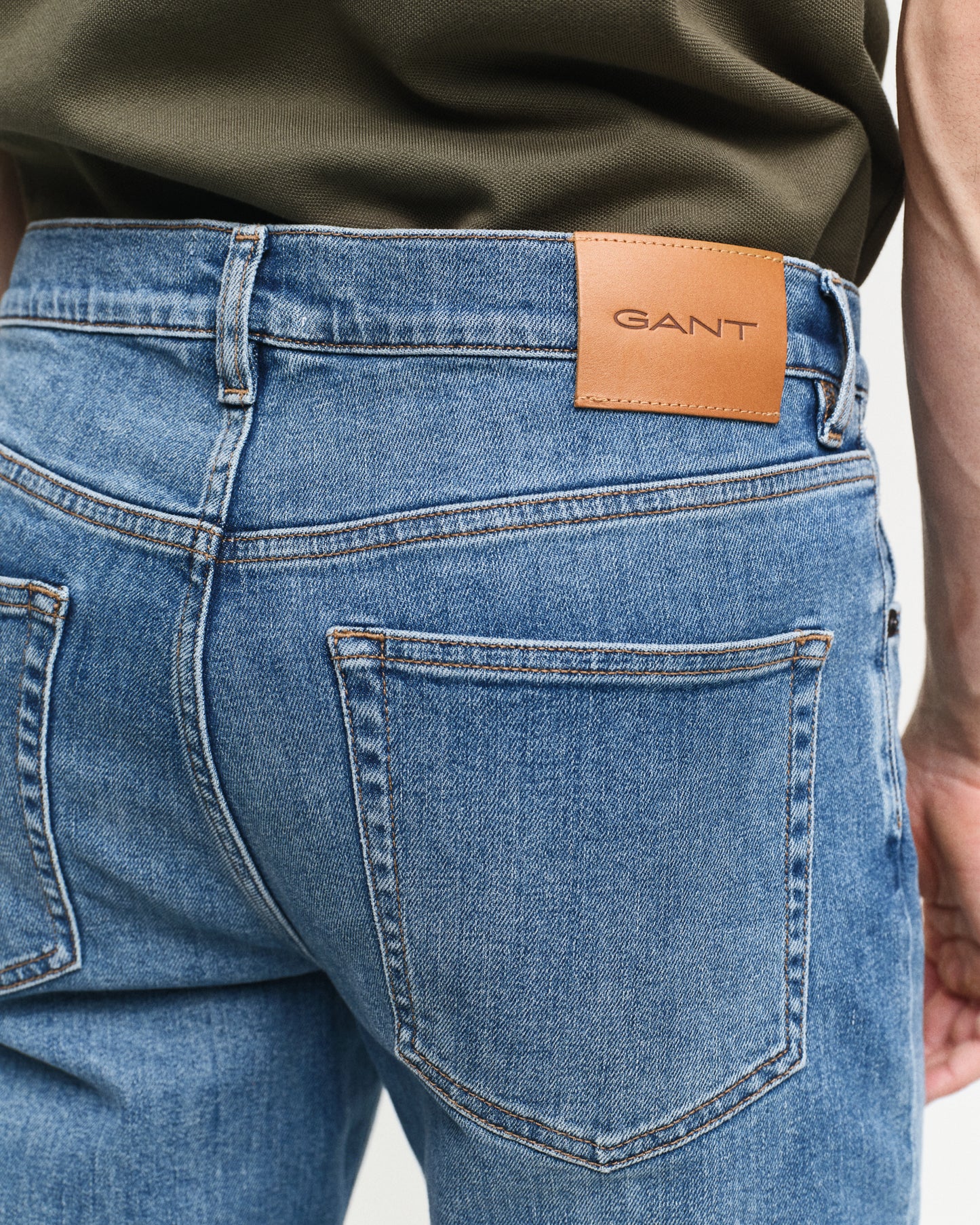 MODEL WEARING SLIM GANT JEANS
