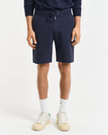 MODEL WEARING REG SHIELD SWEAT SHORTS