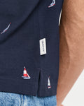 MODEL WEARING EMBROIDERED GRAPHIC POLO
