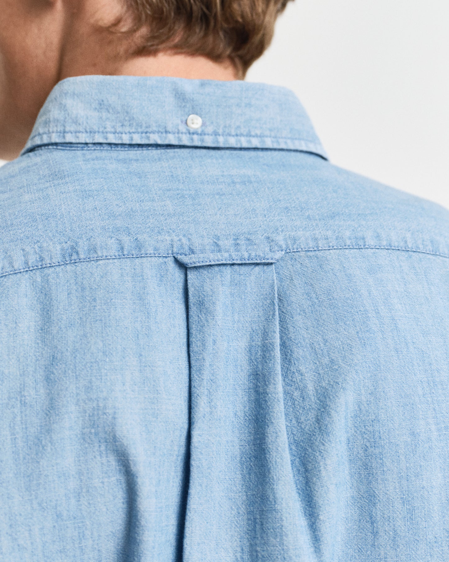 MODEL WEARING REG CHAMBRAY SHIRT