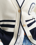 MODEL WEARING GANT VARSITY V-NECK CARDIGAN