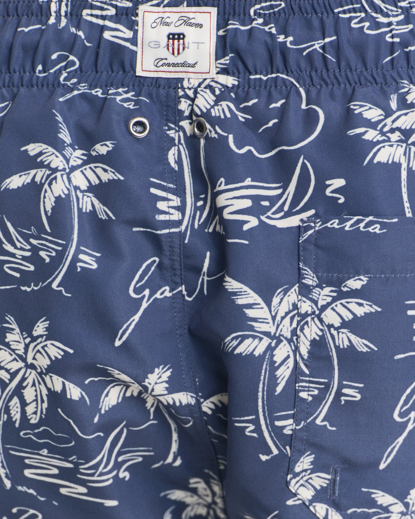 MODEL WEARING ISLAND PRINT SWIM SHORTS