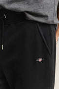 MODEL WEARING REG SHIELD SWEATPANTS