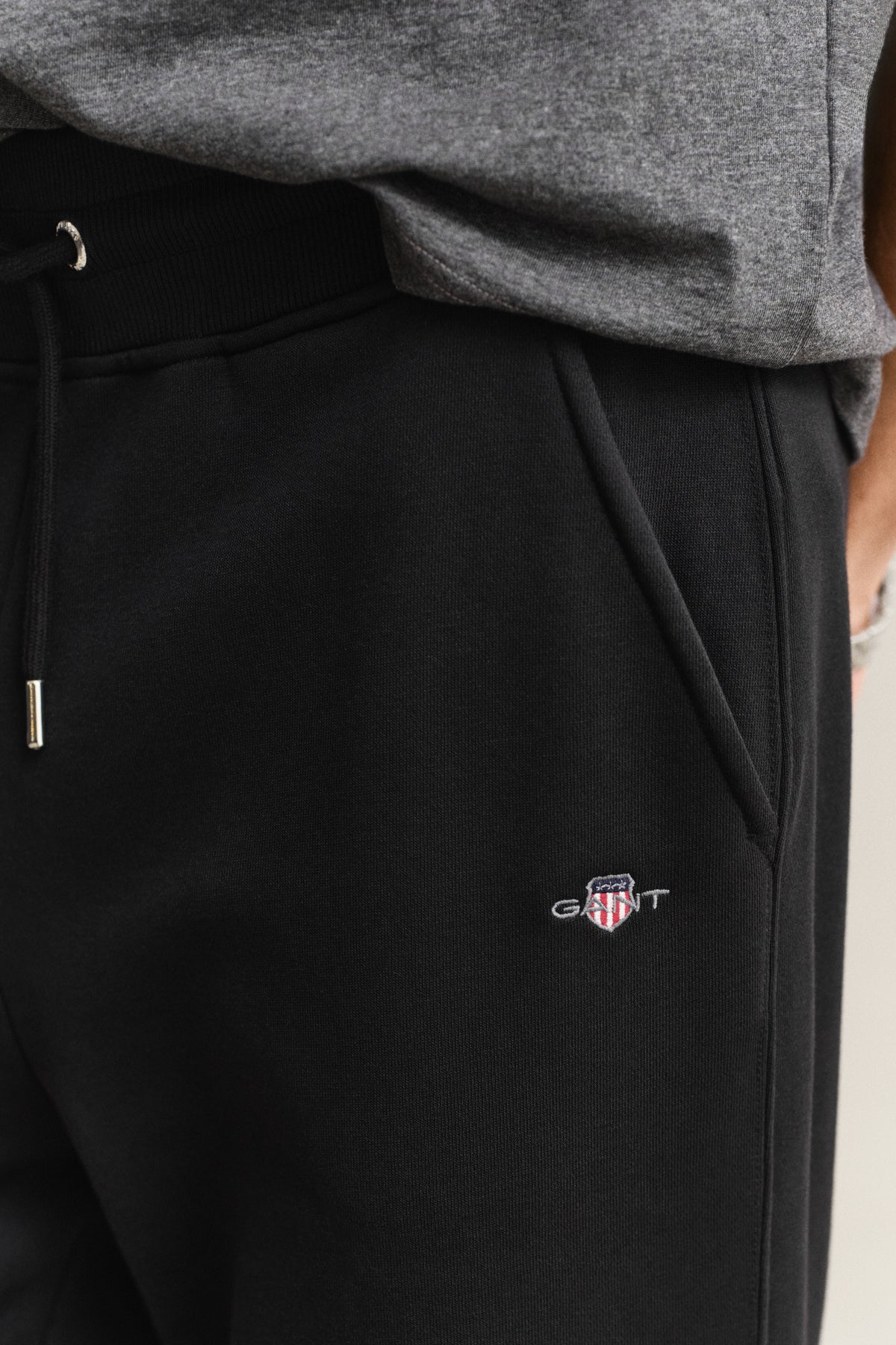 MODEL WEARING REG SHIELD SWEATPANTS