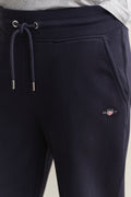 MODEL WEARING REG SHIELD SWEATPANTS