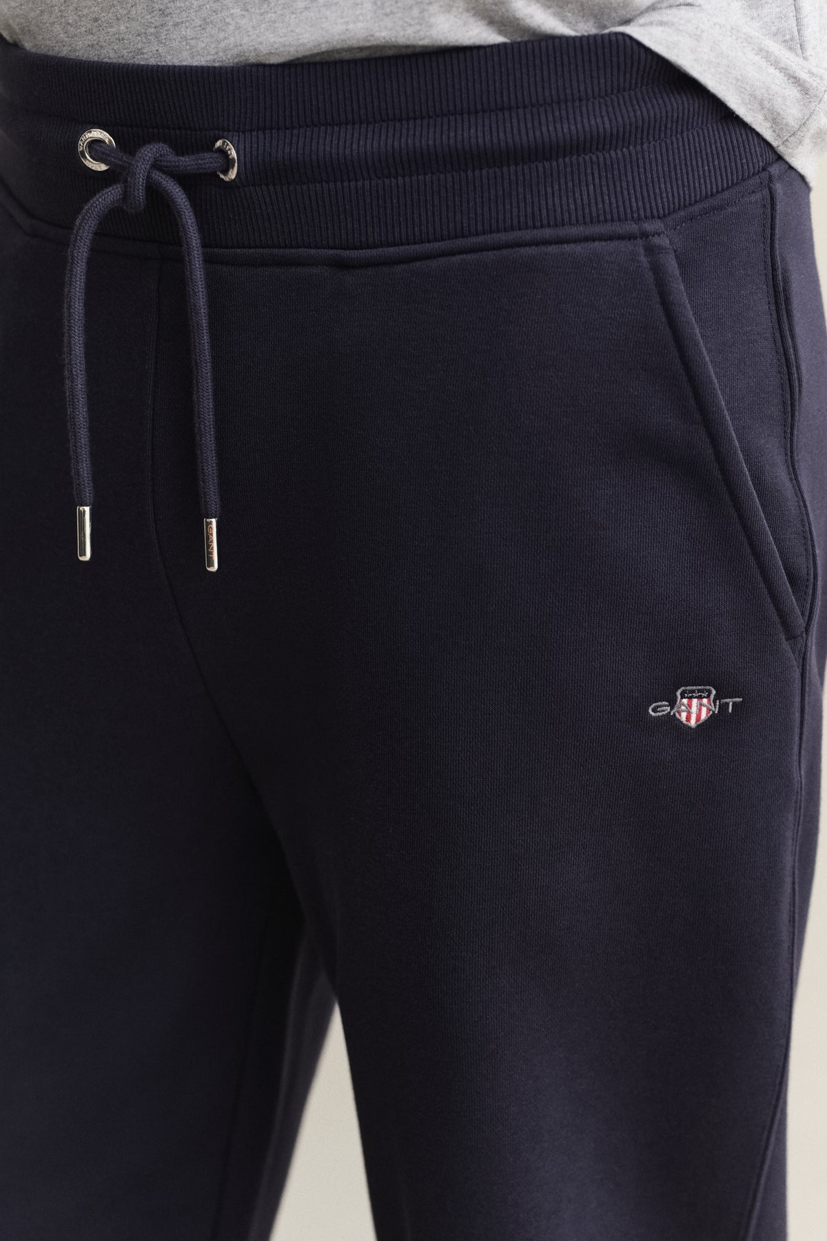 MODEL WEARING REG SHIELD SWEATPANTS