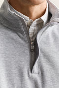 MODEL WEARING LIGHT SACKER HALF ZIP