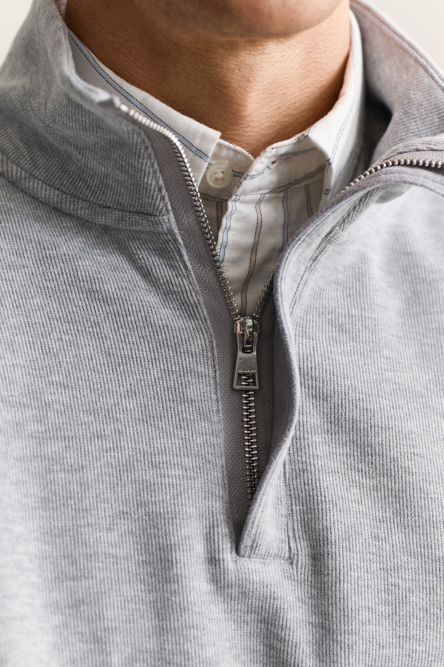MODEL WEARING LIGHT SACKER HALF ZIP