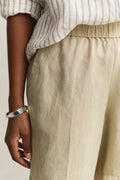 MODEL WEARING LINEN BLEND PULL ON SHORTS