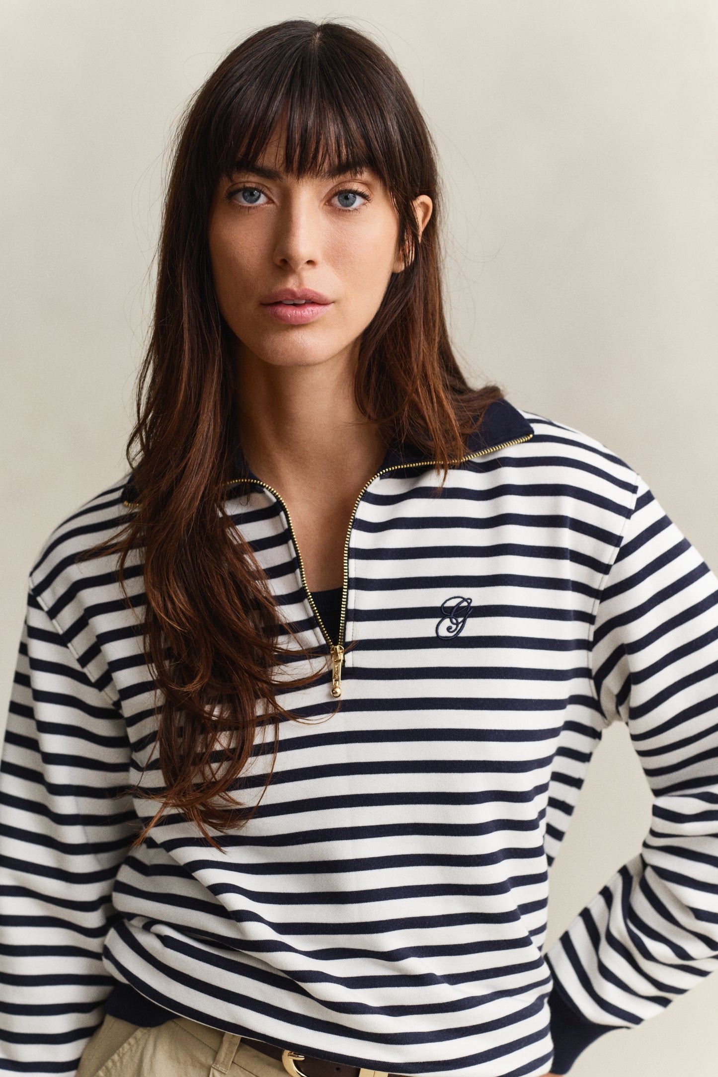 MODEL WEARING STRIPED HALF ZIP SWEAT