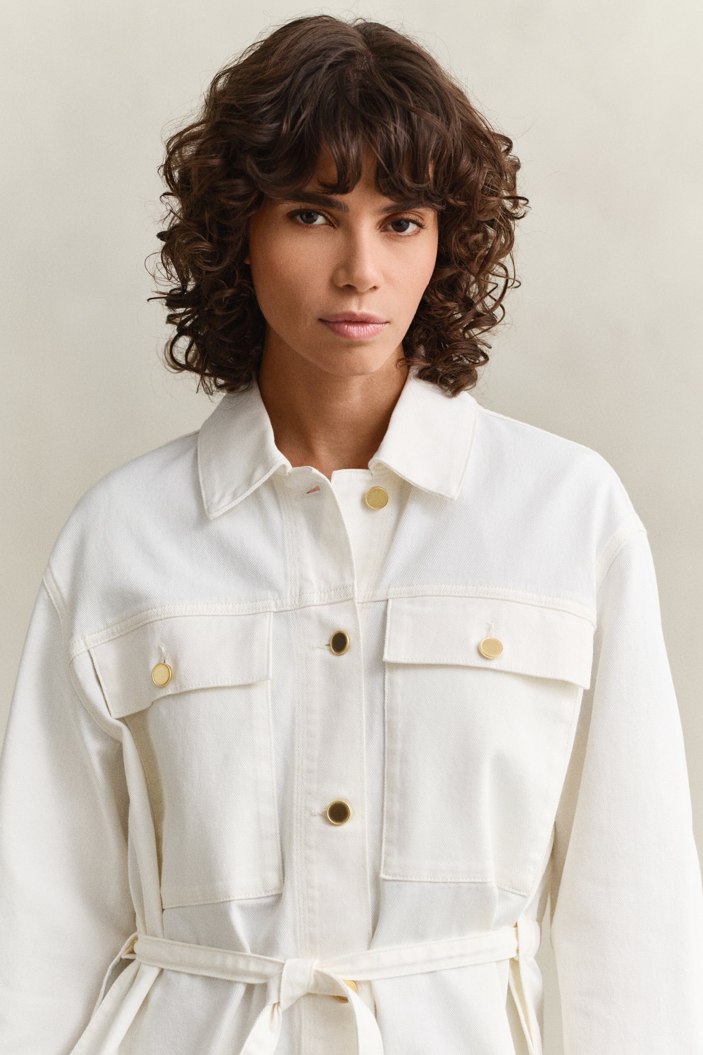 MODEL WEARING DENIM JACKET WITH TIE DETAIL