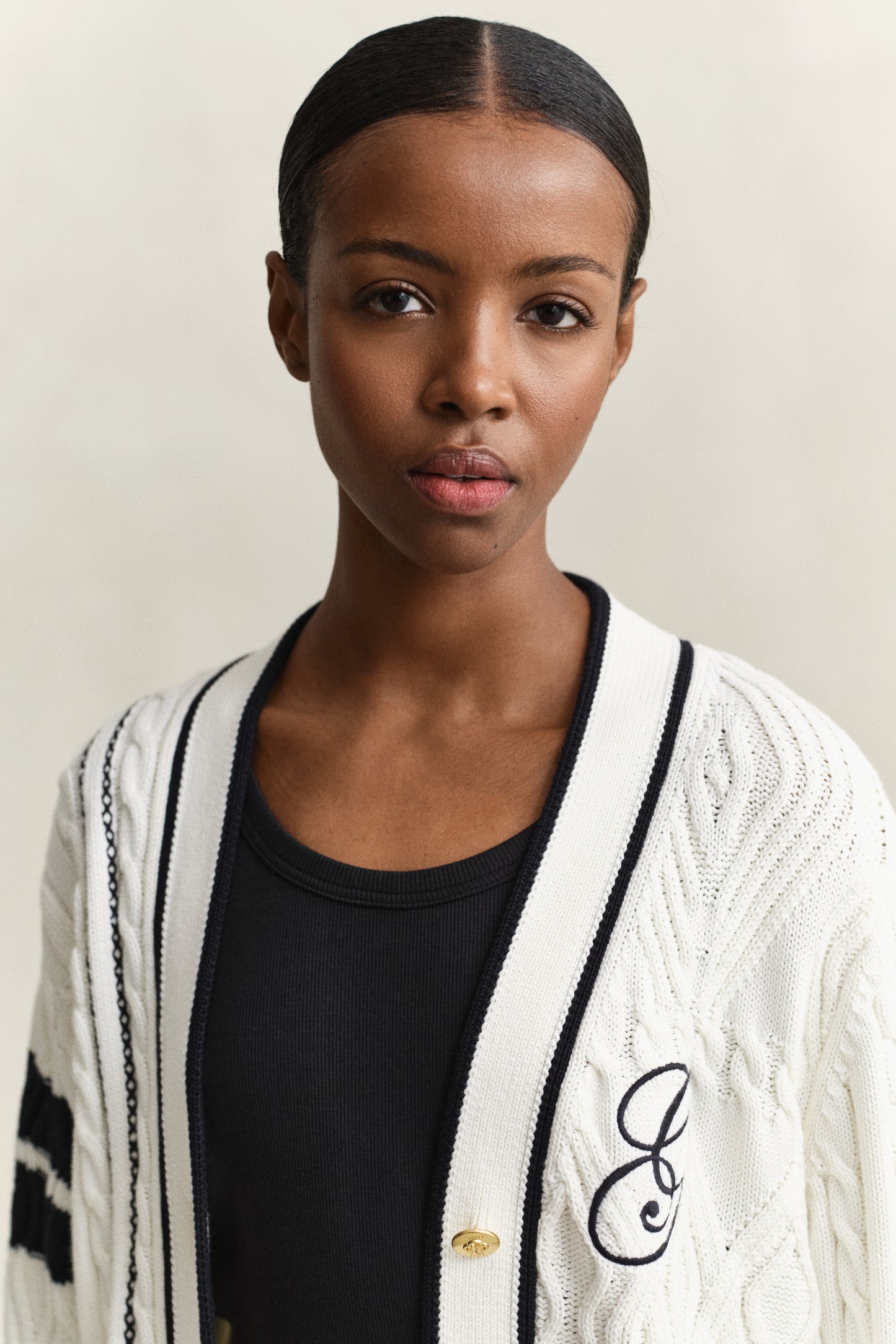 MODEL WEARING GANT VARSITY CABLE CARDIGAN