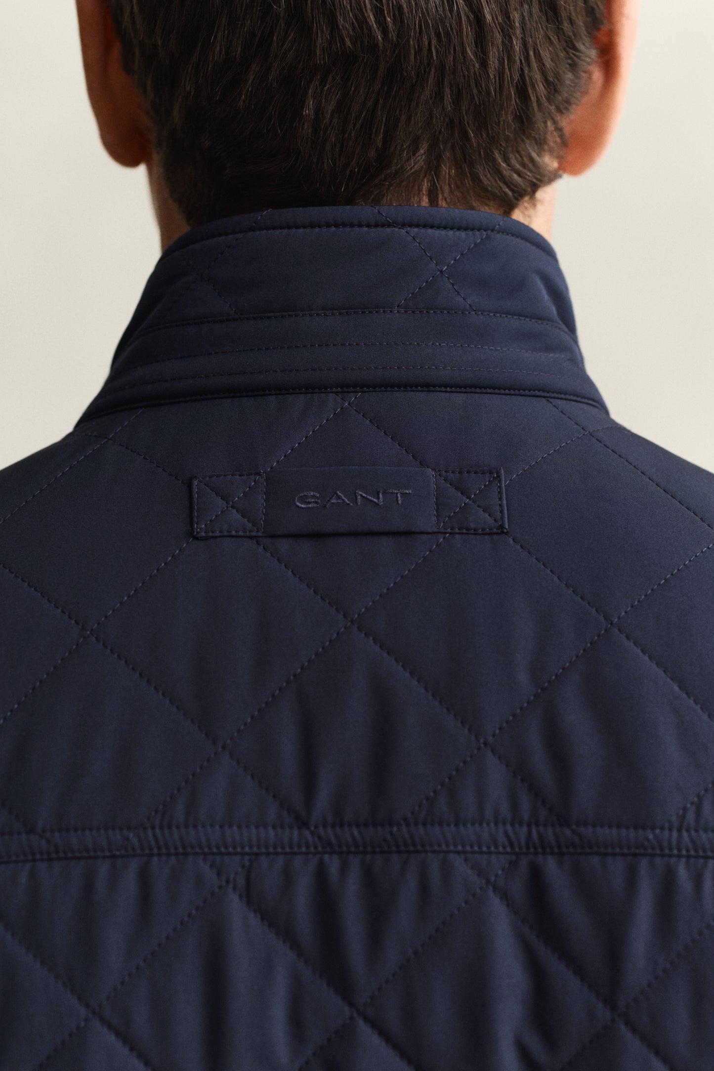 MODEL WEARING QUILTED WINDCHEATER VEST