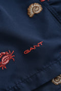 MARINE, LOBSTER EMBROIDERY SWIM SHORTS, FLAT-LAY BY GANT AU.